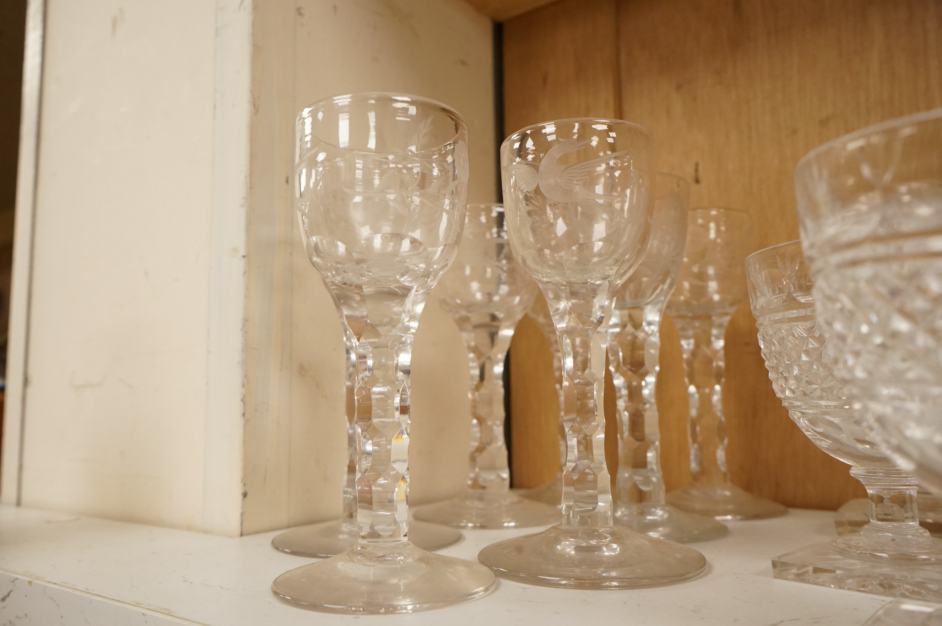 Seven Georgian style facet stem engraved wine glasses and a part suite of 19th centuy rummers, largest 14cm high